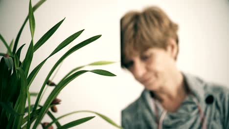 Blurred-worried-sad-mature-woman-resting-on-the-wall