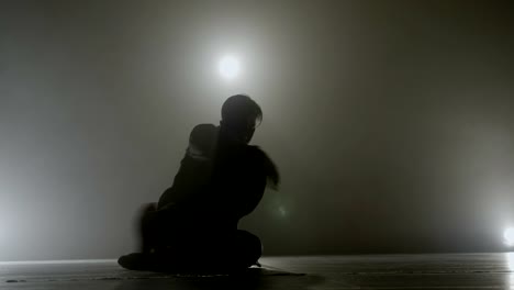 Teenage-student-performing-a-sensitive-sensual-modern-dance-in-front-of-a-smoke-background