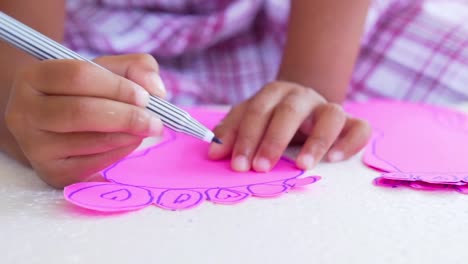 Close-up-kid-hands-using-the-colored-felt-pens-on-paper,-slow-motion-shot-in-50-fps