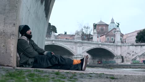 Thoughtful-and-sad-lonely-beggar-smoking-a-cigarette