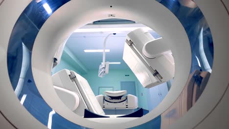 Medical-CT-scanner,-tomograph-works,-and-its-parts-move-slowly.-4K.