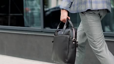 Businessman-with-a-briefcase-Walking-on-Streets-of-Business-District