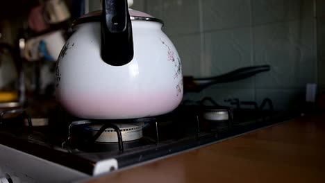 ignites-the-gas-on-the-stove-to-put-the-kettle