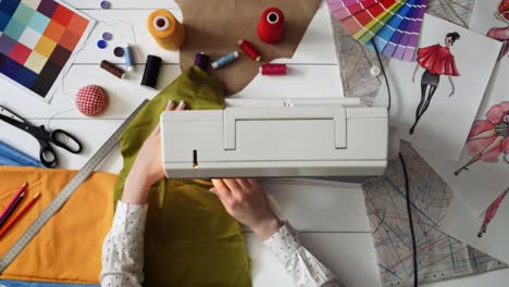 Fashion-designer-working-with-sewing-machine