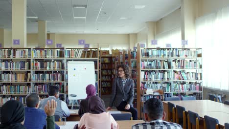 Female-Teacher-Interacting-with-Migrant-Students