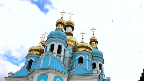 Orthodox-temple,-Clouds-above-the-temple,-golden-domes,-Timelapse,-exterior,-a-view-from-below,-Blue-temple,-blue-church,-Against-the-sky,-Golden-domes