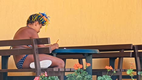 African-ethnicity-girl-painting-on-the-table