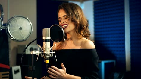 Beautiful-young-singer-who-recorded-a-song-in-a-professional-recording-studio.