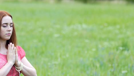 Young-woman-meditates-outdoors,-female-in-namaste-pose-deep-concentration-prayer