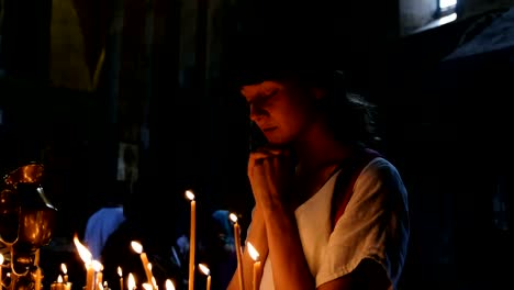 Woman-tourist-prays-in-an-orthodox-Catholic-ancient-temple