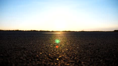 Cars-ride-on-the-asphalt-road-with-beautiful-landscape-at-background.-Vehicles-drive-along-highway-in-countryside.-View-on-the-country-road.-Close-up-Slow-motion