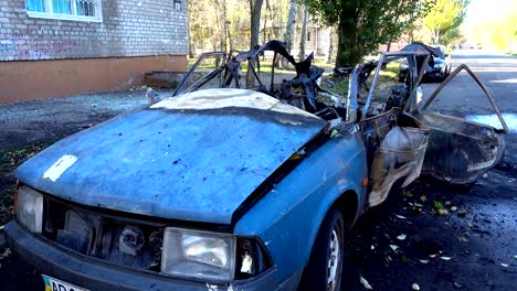 The-blown-up-car-as-a-result-of-terrorist-attack.	Car-after-terrorist-attack.