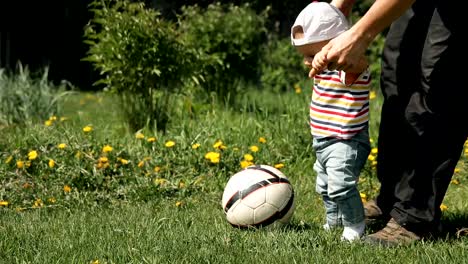 Father-teaches-his-son-to-play-soccer.