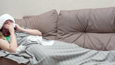 Teenage-girl-blows-her-nose-in-a-paper-handkerchief.-She-has-a-cold