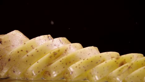 Falling-of-sliced-potatoes-into-the-wet-table.-Slow-motion-240-fps