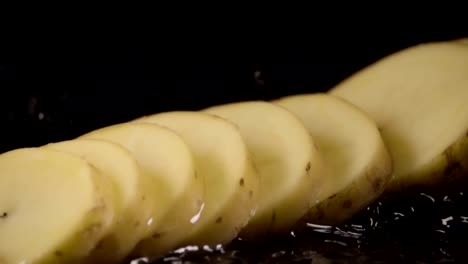 Falling-of-sliced-potatoes-into-the-wet-table.-Slow-motion-480-fps