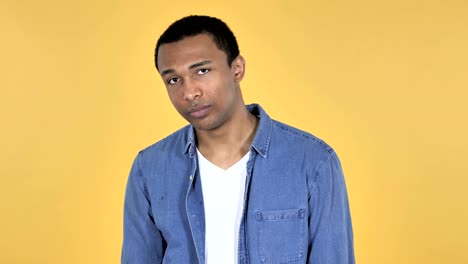 Sad-Upset-Young-African-Man-Isolated-on-Yellow-Background
