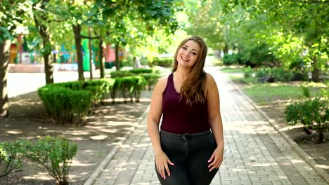 Portrait-of-cute-teenage-girl-with-excess-weight-in-the-city-Park-in-the-summer.