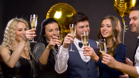 happy-friends-clinking-champagne-glasses-at-party