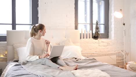 Coughing-Sick-Young-Girl-Working-on-Laptop,-Sitting-in-Bed