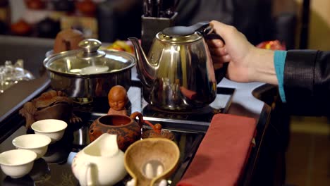 Tea-ceremony.-Tea-maker-pours-boiling-water-into-the-teapot