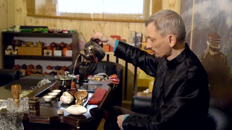 Master-pours-tea-leaves-with-water.-Tea-ceremony