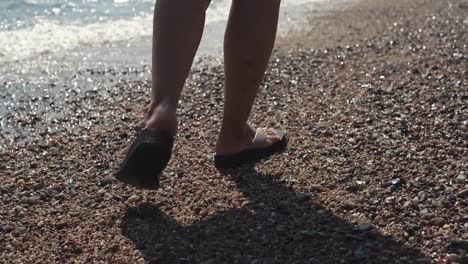 Woman-take-a-walk-along-beach.