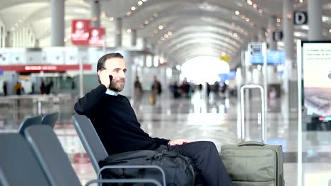 Passenger-talking-on-the-phone-at-the-departure-lounge