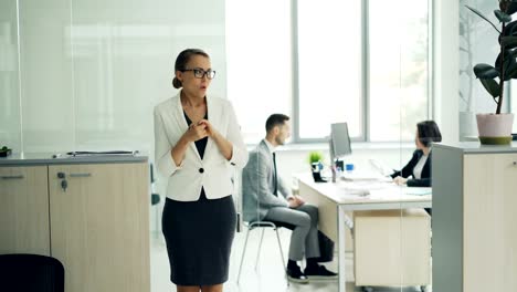 Stressed-woman-is-standing-in-office-room-waiting-for-job-interview-expressing-negative-emotions-fear-and-lack-of-confidence-then-walking-to-interviewer.