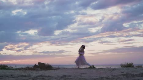 Hermosa-joven-con-maquillaje-brillante-en-un-vestido-rosa-bailando-en-la-orilla-del-río.-La-danza-de-una-sensual-chica-dulce-con-un-peinado-maravilloso-con-flores.-Cámara-lenta.