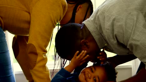 Side-view-of-young-black-parents-playing-with-their-son-in-a-comfortable-home-4k