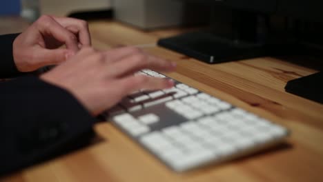 Businessman-with-suit-hands-typing-in-the-desk-office