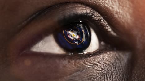 Woman-black-eye-in-close-up-with-the-flag-of-Utah-state-in-iris,-united-states-of-america-with-wind-motion.-video-concept