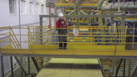 Male-Quality-Controller-Checking-Slabs-of-Rockwool-on-Conveyor-Belt