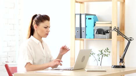 Woman--Upset-by-Loss,-Working-on-Laptop