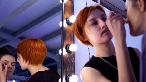 Concept-of-beauty-and-fashion.-Professional-makeup-artist-applying-cosmetics-on-model-face.-Loop