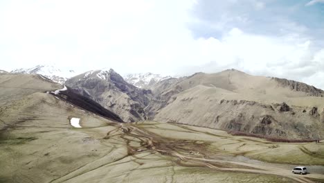 Off-road-vehicle-crossing-mountain-top-moving-down