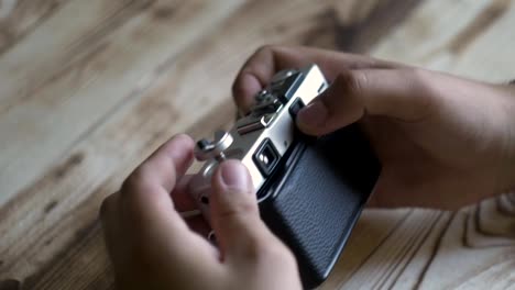 Closeup-of-male-hands-set-new-film.-vintage-camera.-rangefinder-camera