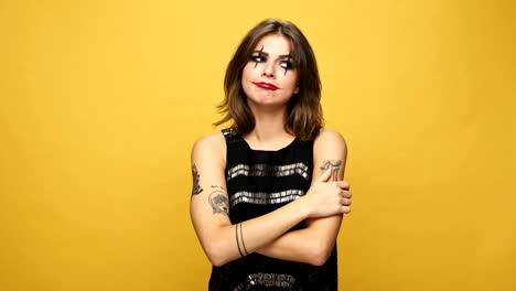 Thoughtful-pensive-lady-with-funny-halloween-make-up-having-no-idea-what-to-do-isolated-over-yellow