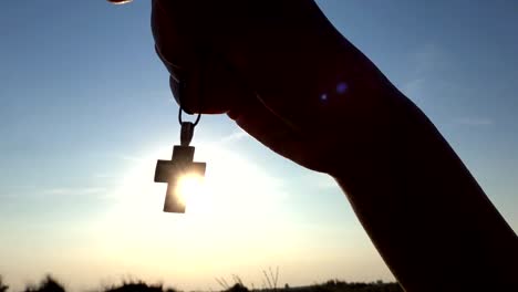 Closeup-Of-Silhouette-Cross-Hanging-at-sunset/sunrise-time