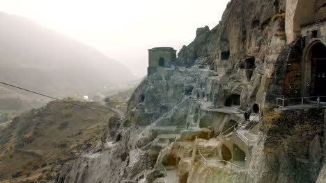 VARDZIA,-GEORGIA---October-17,-2017:-People-sightseeing-Vardzia-Cave-Monastery-Site-in-Georgia-at-the-Erusheti-Mountain.