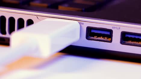 Closeup-of-HDMI-cable-plug-inserted-into-port-on-the-side-of-a-laptop