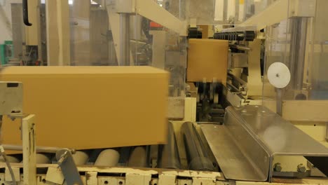 Folding-cardboard-boxes-on-a-conveyor-belt-in-a-rice-factory-–-4K