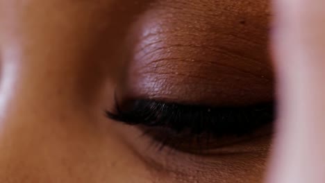 Close-up-makeup-artist-combing-eyebrows-after-painting-with-pencil-or-shadows