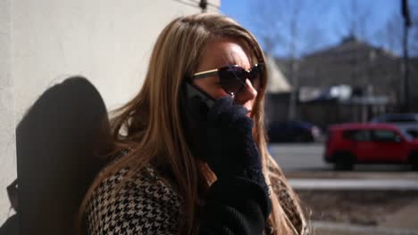 A-sad-blonde-woman-is-upset-after-being-let-go-from-her-job-and-makes-a-phone-call