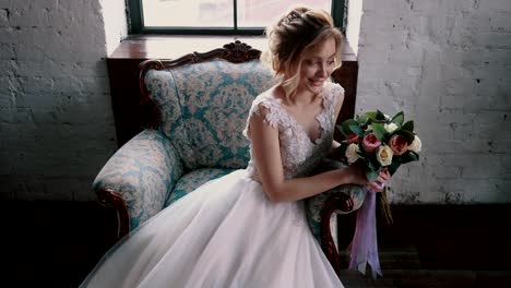 young-bride-holding-a-bouquet-sitting-in-a-chair