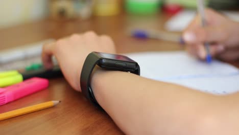 Schoolboy-with-smart-watch-in-the-classroom