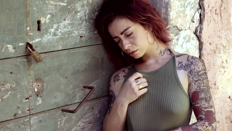 Depressed-sad-lonely-tattooed-woman--outdoor