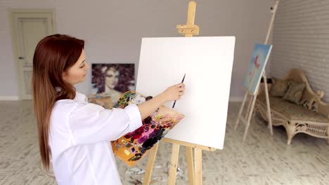 Portrait-of-a-artist-girl-in-front-of-white-canvas