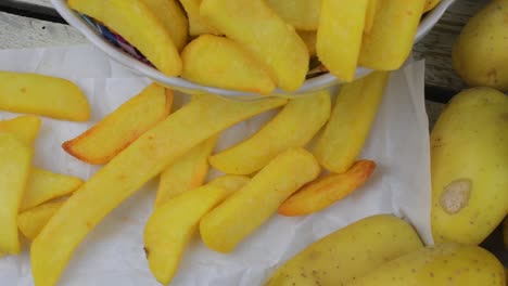 Homemade-baked-potato-fries-on-white-wooden-board.-Top-view.-Flat-view